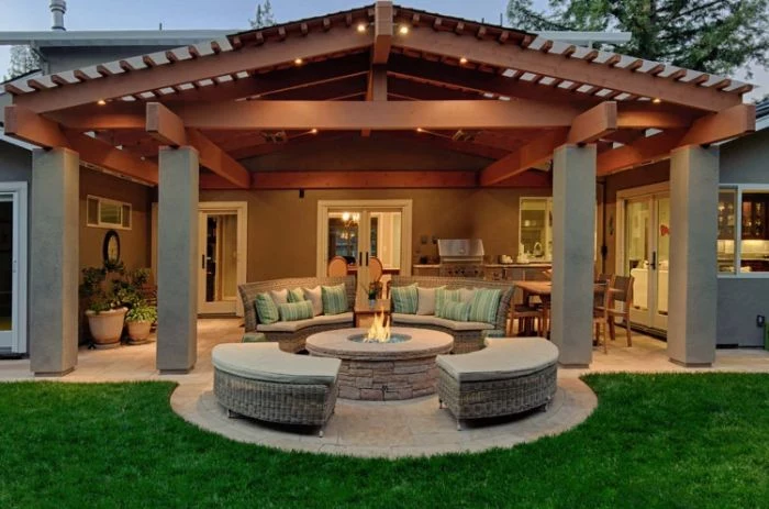enclosed lounge area with blue throw pillows backyard fire pit ideas rattan furniture