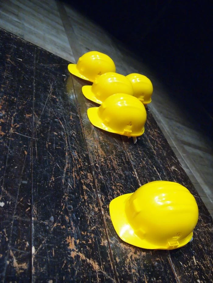 five yellow safety hats placed on dark wooden floor construction business ideas