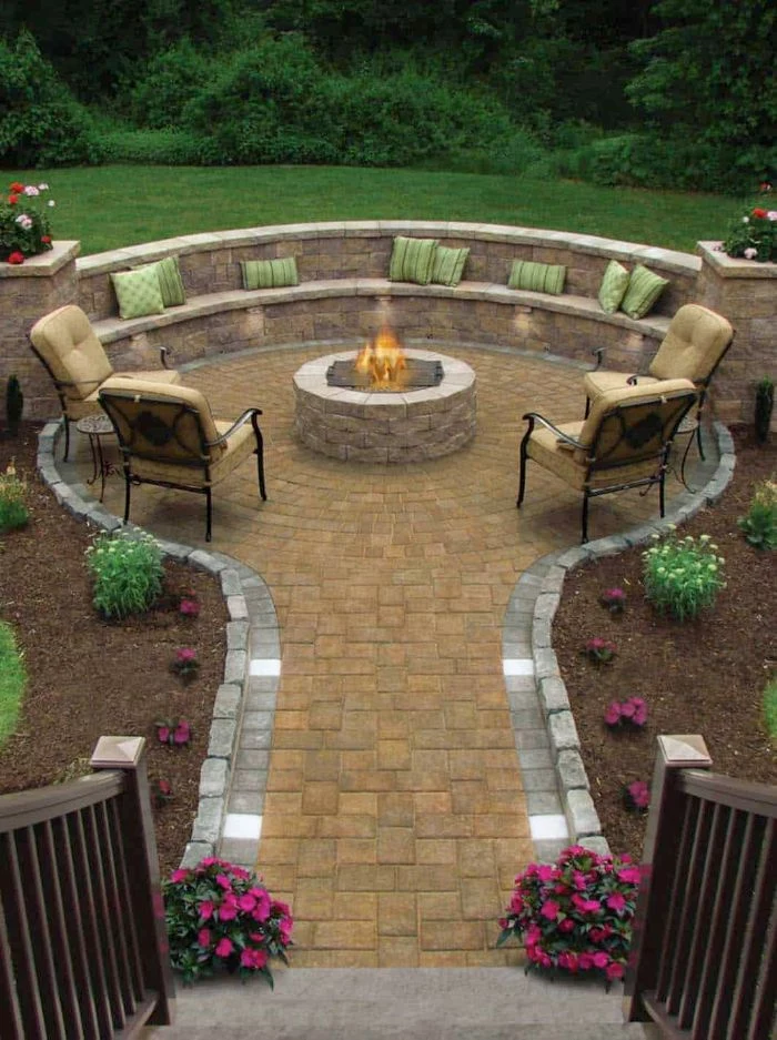 four lounge chairs bench homemade fire pit round made of stones pathway leading to it