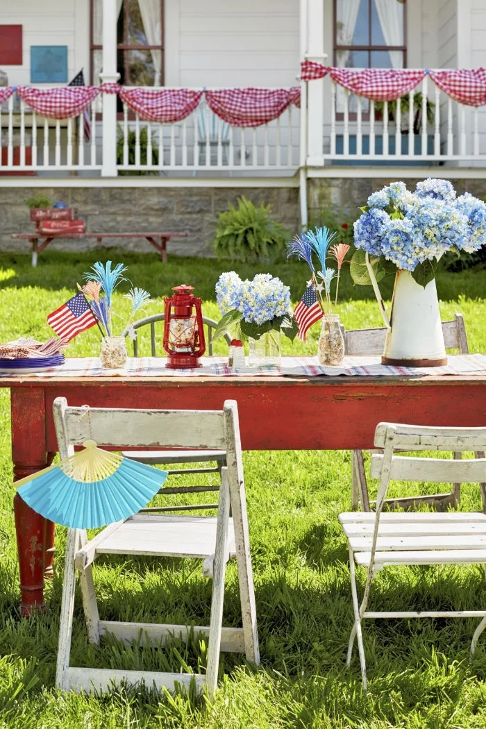 fourth of july crafts wooden table and chairs in the backyard decorated with american flags blue flowers