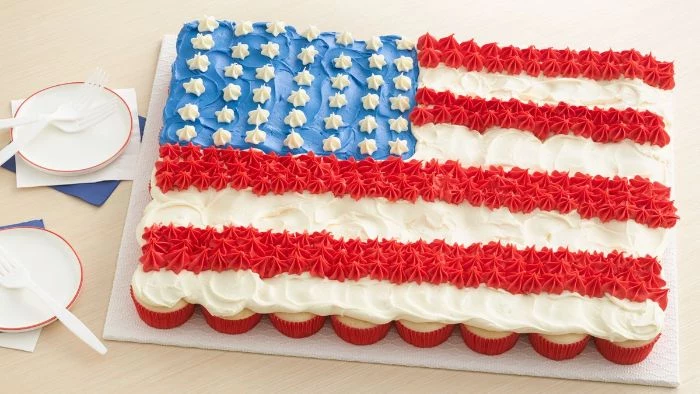 fourth of july desserts cupcakes arranged on platter decorated in red white blue frosting as the american flag