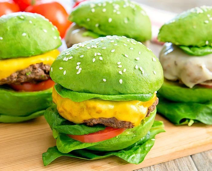 green avocado buns with sesame seeds best burger recipe vegan burger placed on wooden cutting board