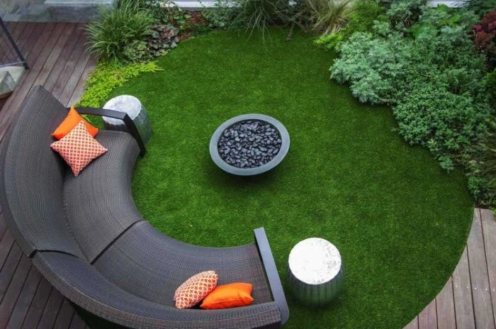 half moon sofa with orange throw pillows outdoor fire pit ideas concrete bowl filled with rocks