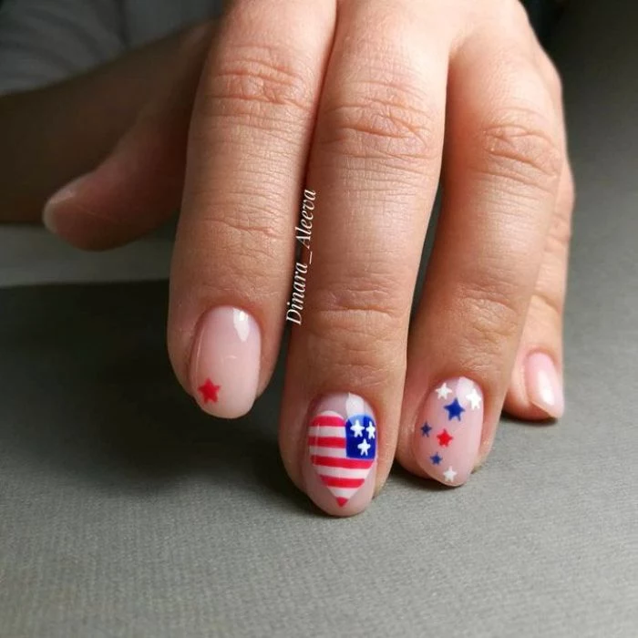 heart shaped american flag on the middle finger 4th of july nail designs red white and blue stars