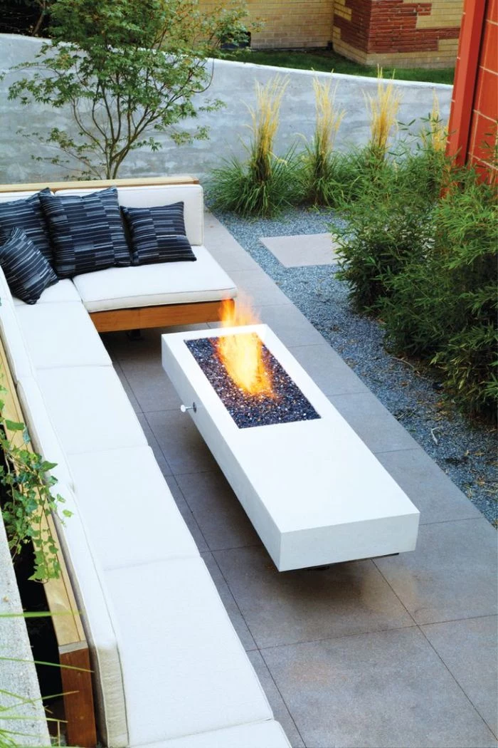 how to make a fire pit wooden bench with white cushions blue throw pillows concrete fire pit with rocks