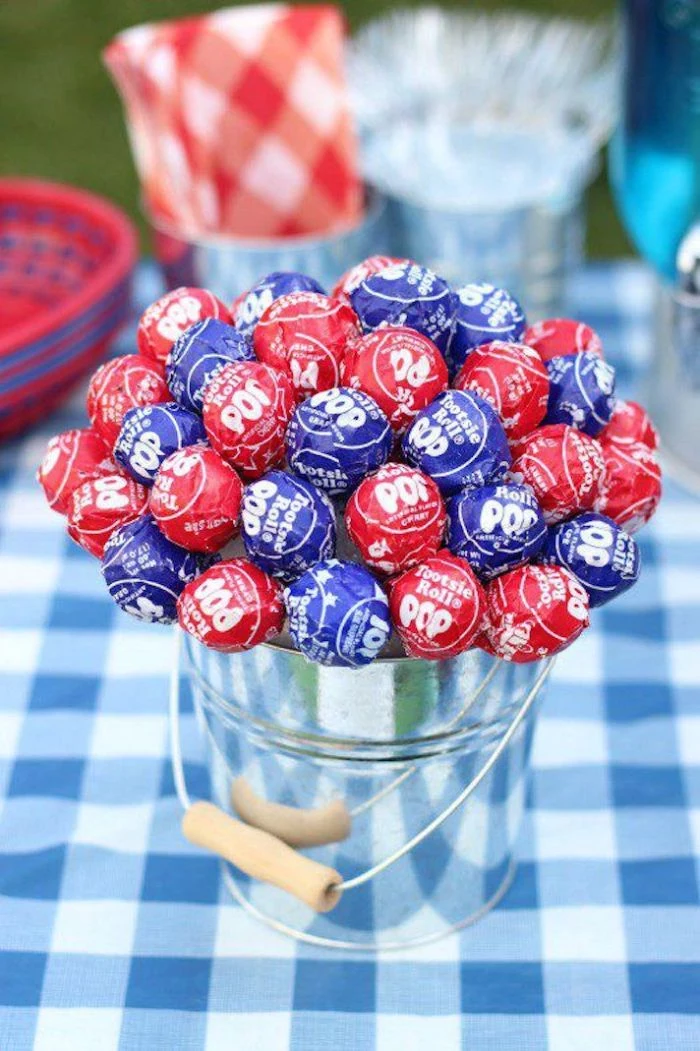 lollipops in blue and red arranged as bouquet inside bucket fourth of july crafts table centerpiece