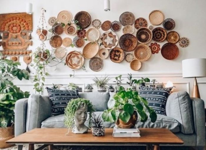 lots of baskets arranged on white wall with different patterns décor ideas for living room above gray sofa