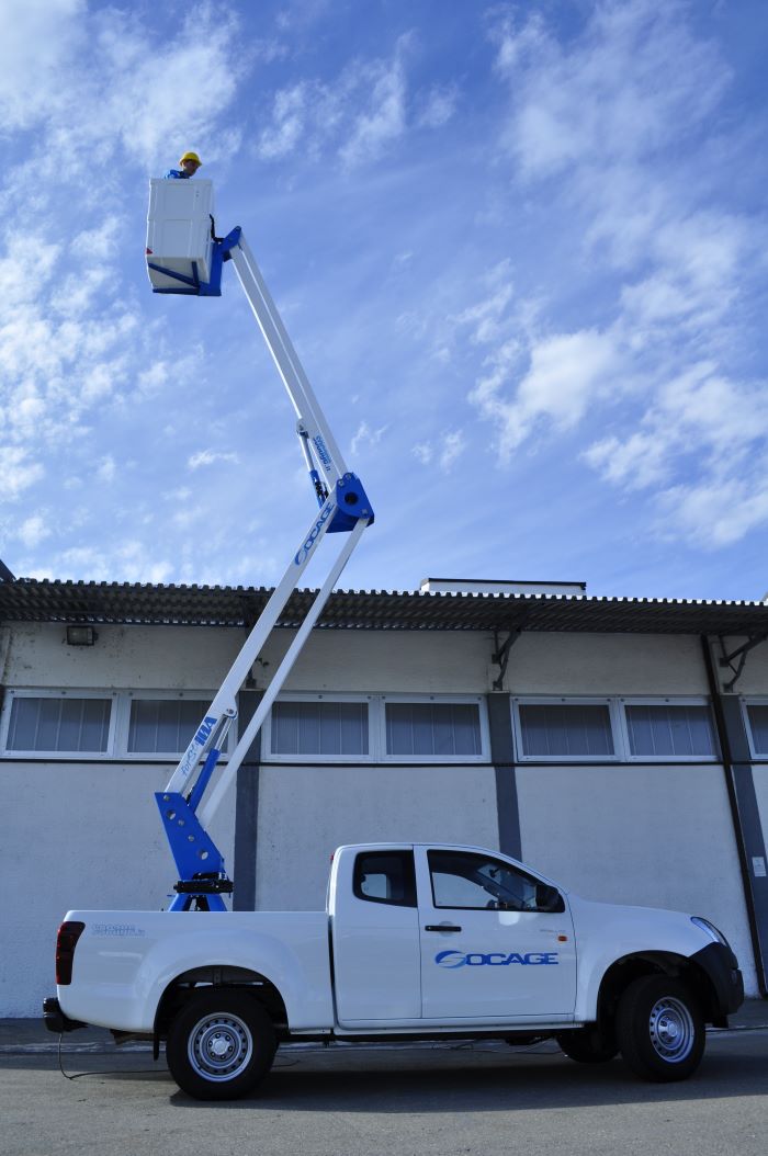 man standing on aerial platform on truck international consolidation strategy in front of warehouse