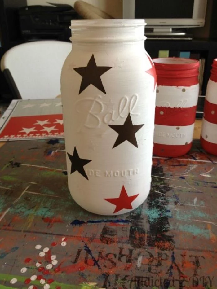 mason jar painted in white 4th of july banner step by step diy tutorial for candle holder