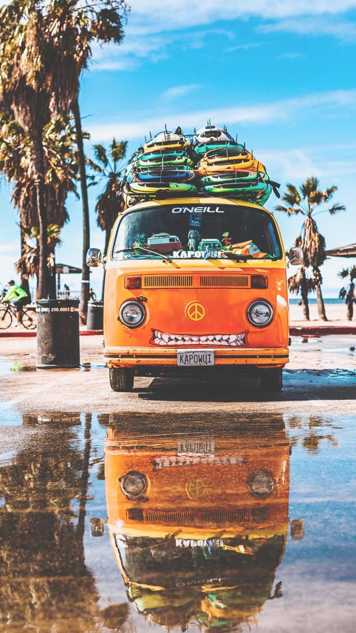 orange van with surfs on it parked next to the beach best summer wallpapers