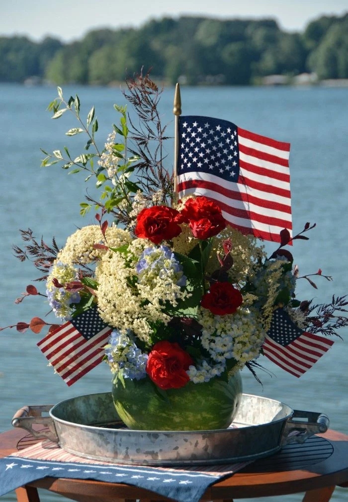 patriotic decorations watermelon planter filled with red white and blue flowers decorated with american flags