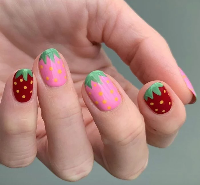 pink and red strawberries drawn on each nail cute acrylic nail ideas short squoval nails