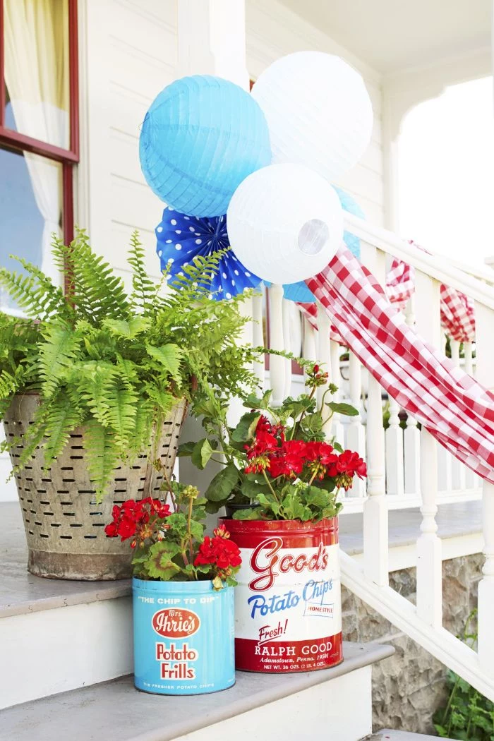 planters in red white and blue with red flowers fourth of july decorations placed on front stairs