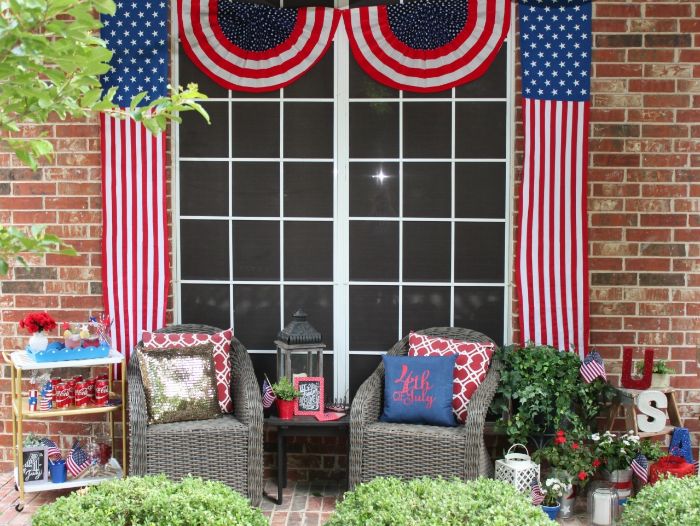porch with garden furniture 4th of july wreath american flags hanging next to windows