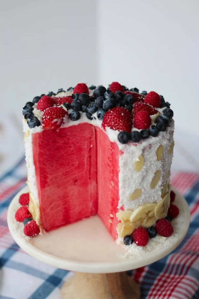 red white and blue desserts watermelon cake decorated with blueberries strawberries bananas coconut flakes