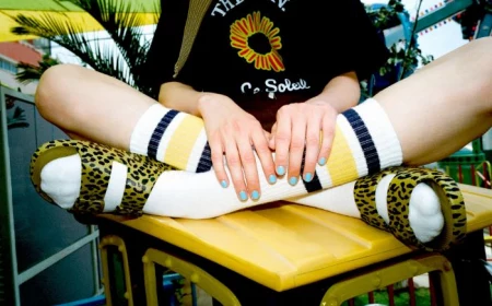 short squoval nails with blue nail polish cute nail designs girl sitting on top of table wearing leopard print sandals
