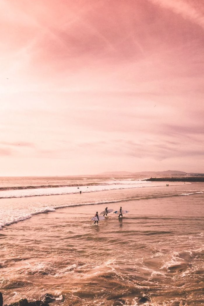 summer wallpaper hd pink aesthetic three surfers getting out of the water at sunset
