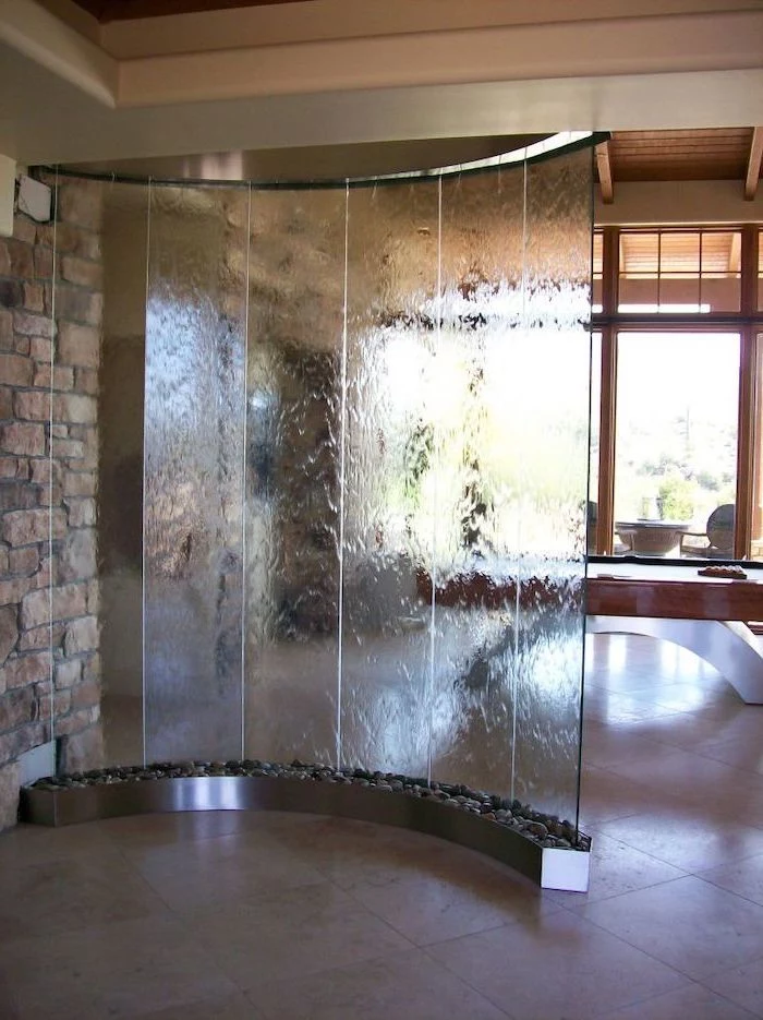 tabletop water fountain room divider made of glass water falling down into pot of rocks