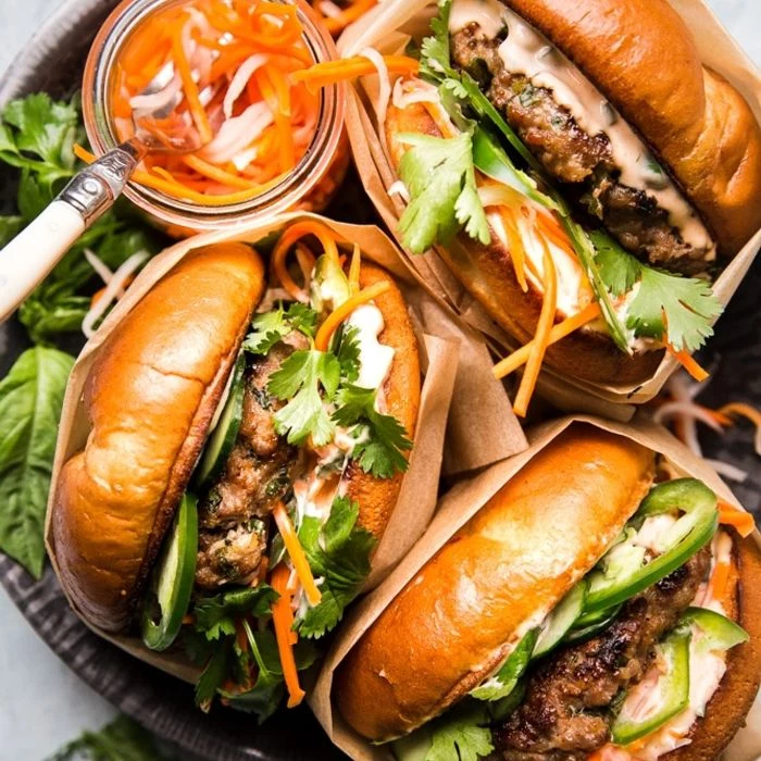 three burgers wrapped in paper garnished with parsley best burger recipe placed in bowl