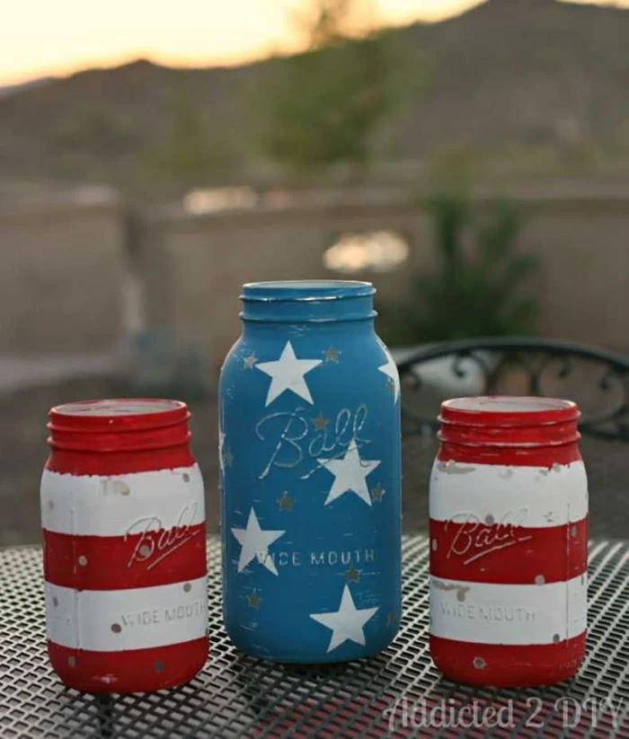 three mason jars painted in red white and blue 4th of july banner stars and stripes