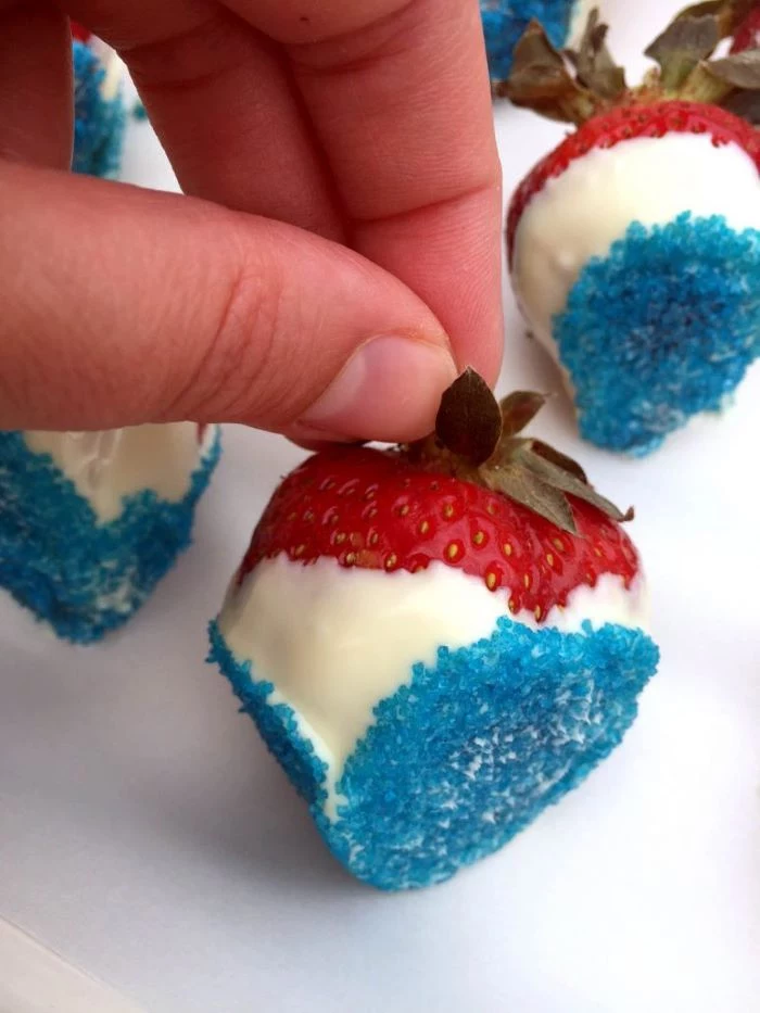 traditional 4th of july foods strawberries dipped in white chocolate decorated with blue sugar