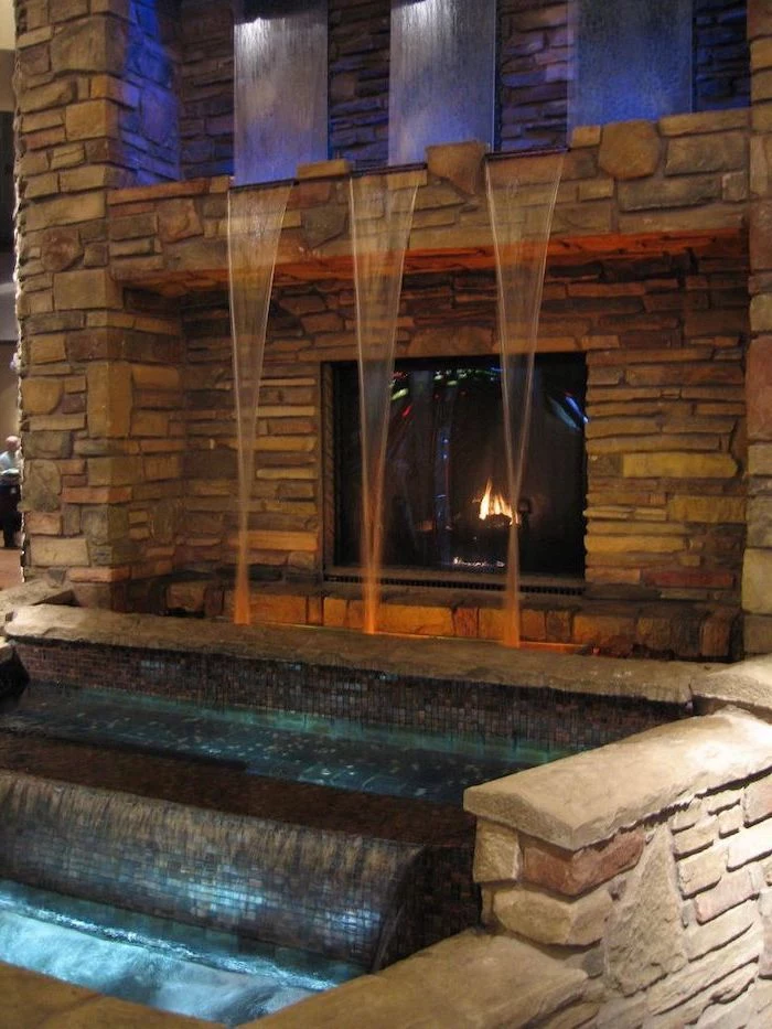 water streaking down in three different placed into pool indoor tabletop fountain over fireplace