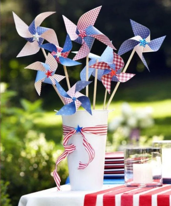 white bucket table centerpiece with paper fans in red white and blue 4th of july wreath