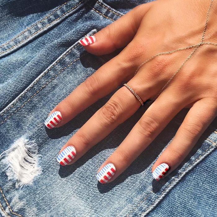 white nail polish with red and blue stripes decorations on each nail 4th of july nail designs
