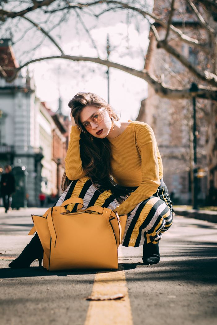 woman wearing mustard blouse yellow black white striped skirt yellow bag women fashion for summer 2021