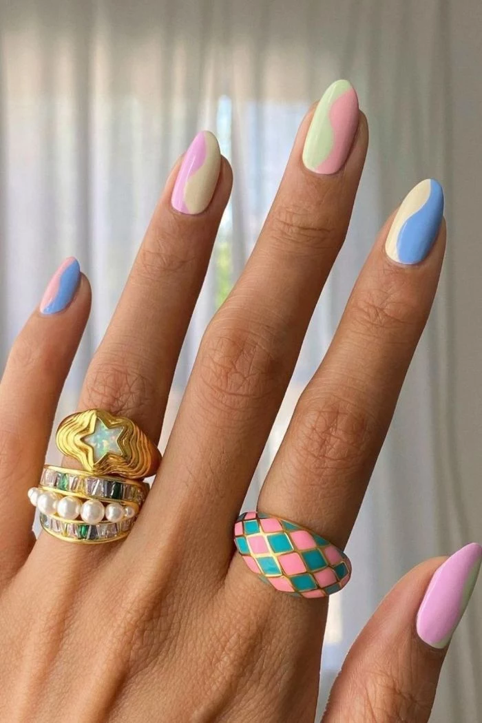 acrylic nail ideas rainbow nails with swirls in pink yellows blue green purple on medium length nails