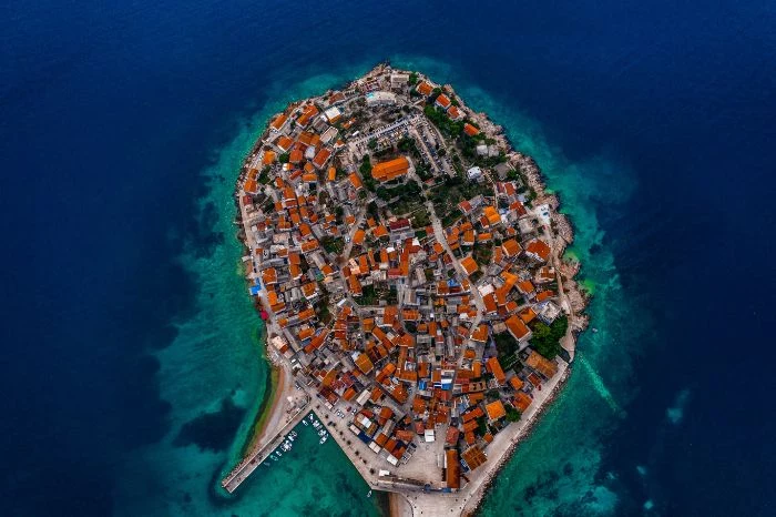 aerial view of hrvoje croatia beach aesthetic lots of houses and buildings on the island surrounded by blue water
