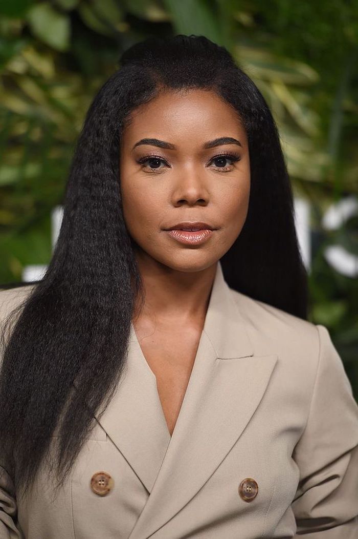 black hair crimped bob gabrielle union photographed on red carpet wearing gray jacket