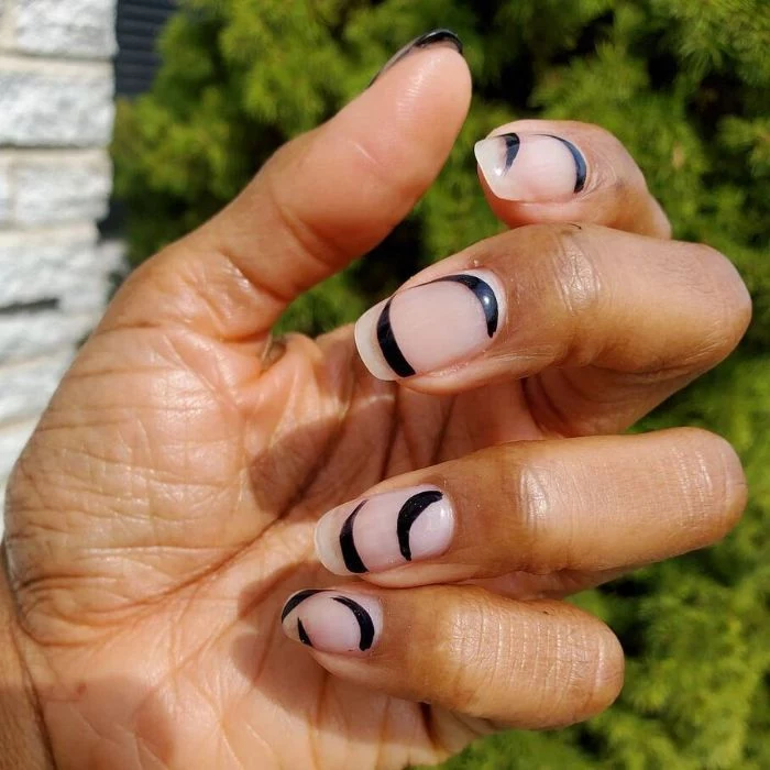 black swirls and lines on nude nail polish nail design ideas medium length nails with minimalistic design