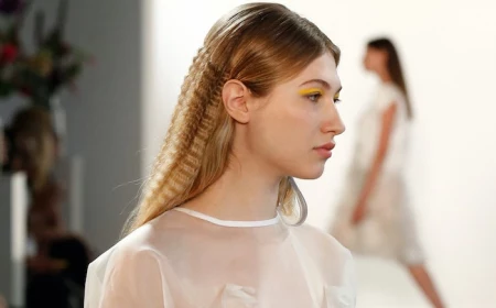 blonde model on the runway how to crimp hair wearing white top yellow eyeliner
