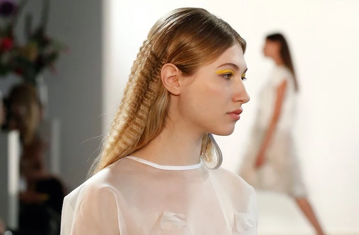 blonde model on the runway how to crimp hair wearing white top yellow eyeliner