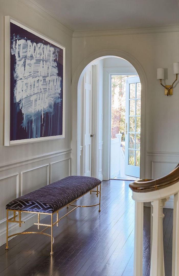 blue leather bench with gold metal frame entryway design ideas blue and white art hanging above it