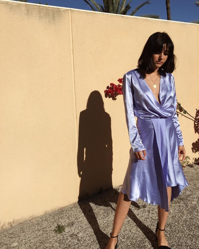 blue satin dress with long sleeves fourth of july outfits worn by woman with shoulder length black hair