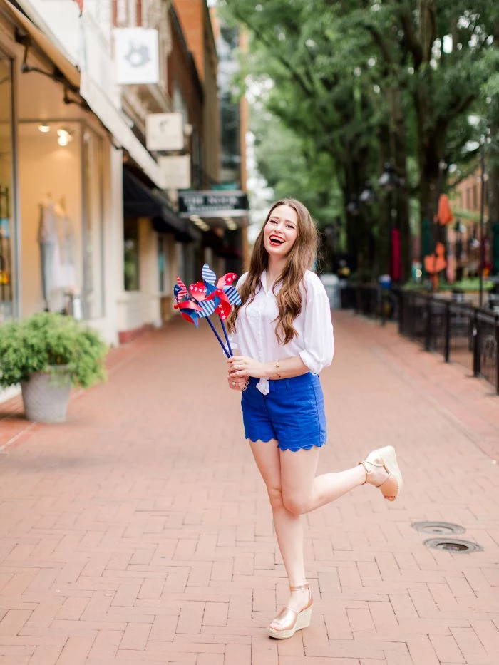 blue shorts white blouse platform sandals 4th of july clothes worn by woman with long hair