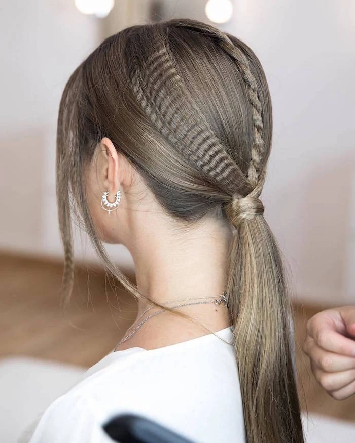 braid and crimped strands of hair tied in low ponytail short crimped hair woman with dark blonde hair