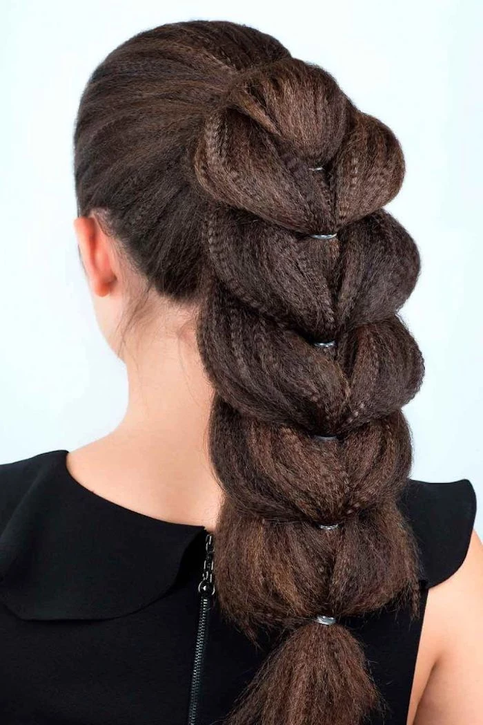brown hair in high pontail braided in messy braid wavy crimped hair on woman wearing black top