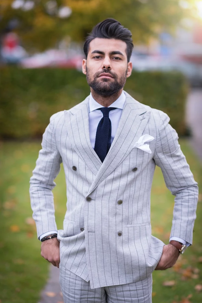 brunette man wearing gray suit with blue tie coconut oil hair mask short black hair beard