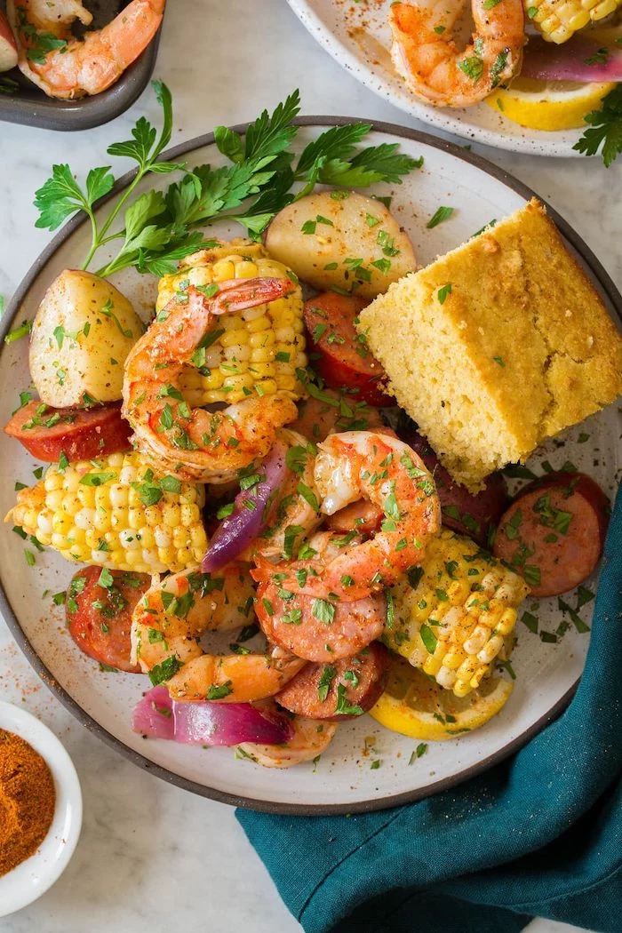 cajun seafood boil recipe shrimp boil with potatoes sausages corn on the cob garnished with fresh parsley