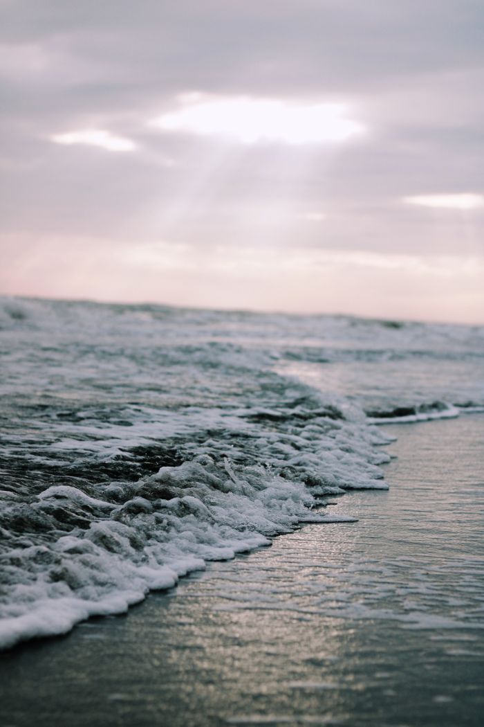 close up photo of waves crashing into the beach beach background hd cloudy sky