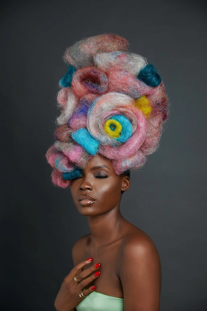 colorful rainbow hair done in artistic way coconut oil hair mask woman wearing green top red nail polish