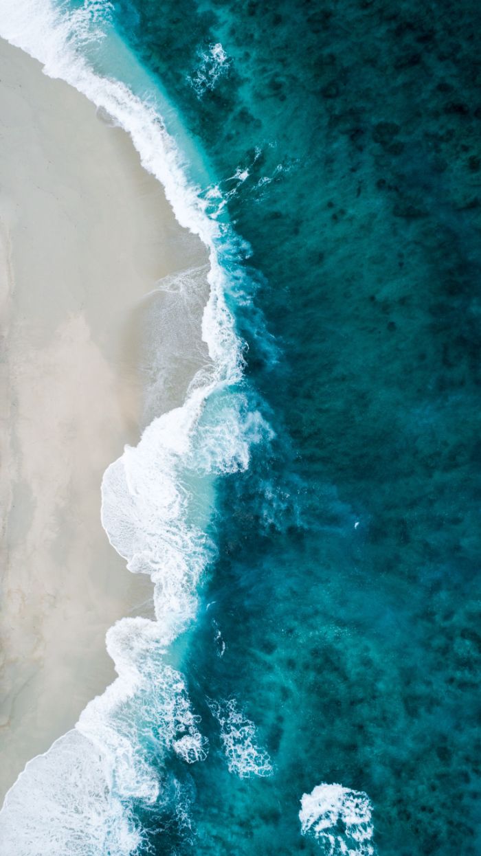 dark blue water beach background images waves crashing into beach with white sand