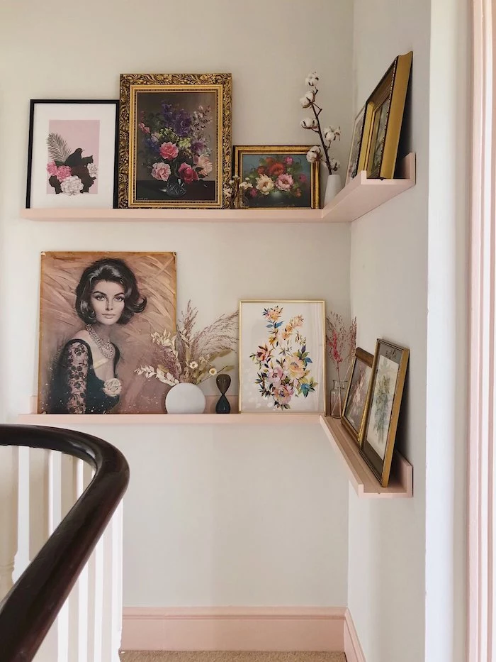 decorating ideas for stairs and hallways framed art and flowers in vases placed on floating shelves