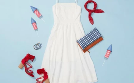 fourth of july shirts white dress red sandals blue and white leather bag layed out on blue surface