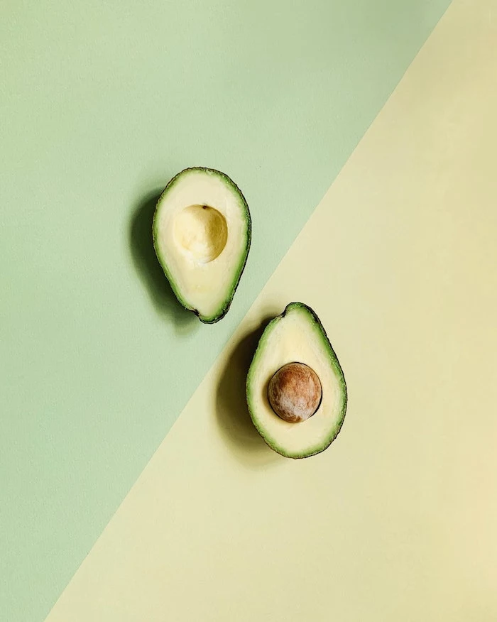 half yellow half green background home remedies for dry hair halved avocado in the middle