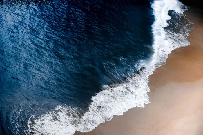 iphone beach wallpaper dark blue waves crashing into sandy beach