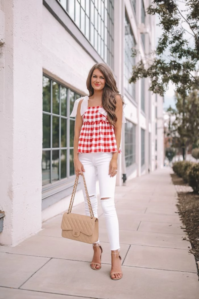 jeans in white with red and white checkered top worn by woman with long hair 4th of july dress nude sandals and bag
